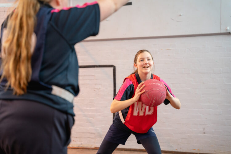 Student playing netball Shrewsbury Academy | Marches Academy Trust